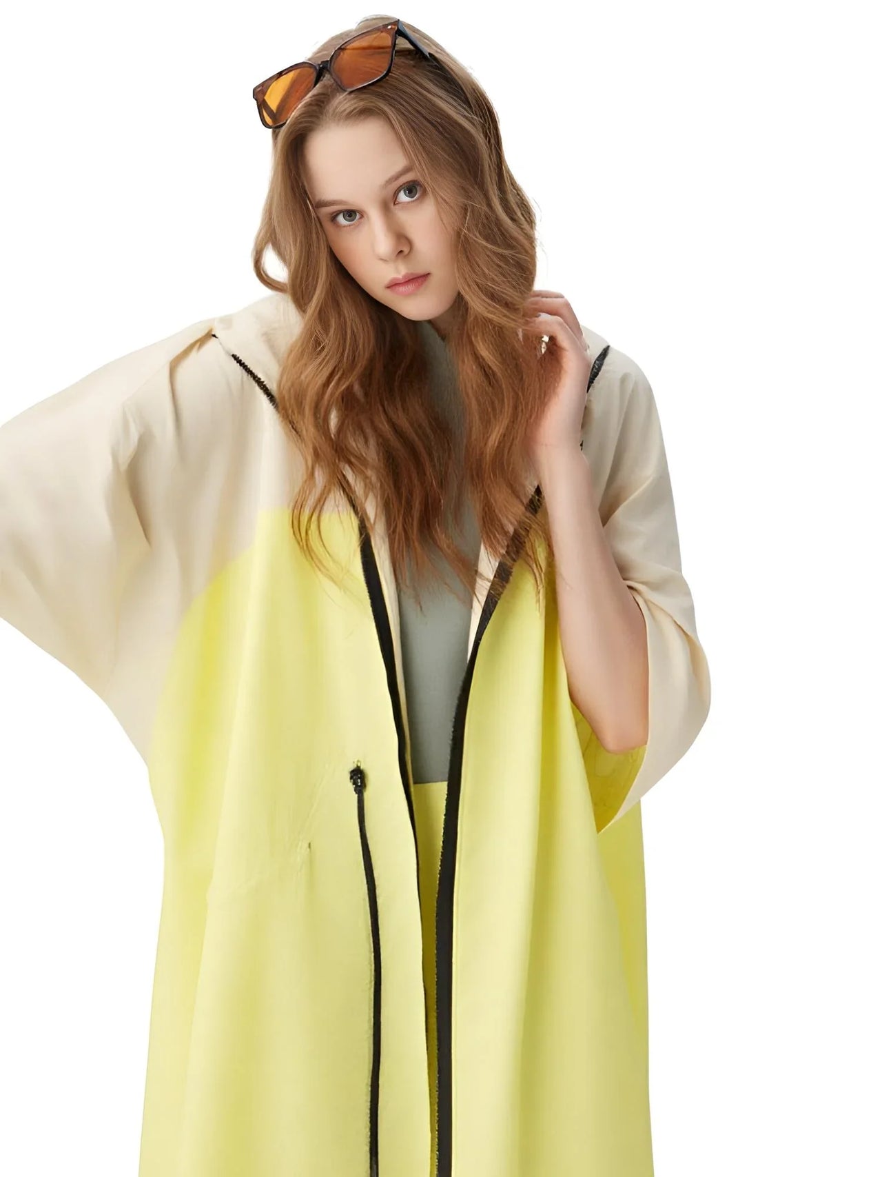 Woman wearing a light-colored jacket with a yellow hood on a white background