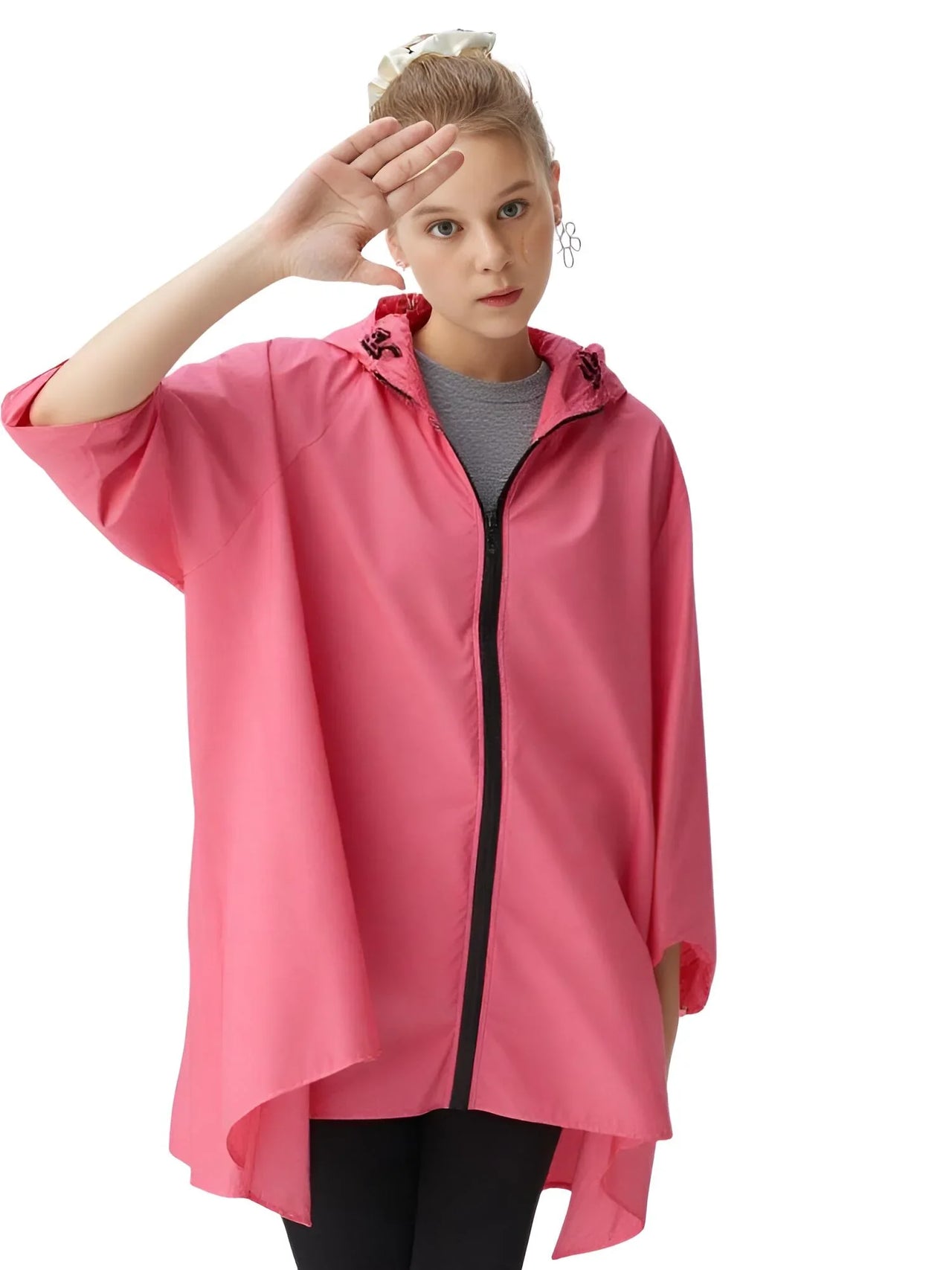 Person wearing a pink raincoat on a white background