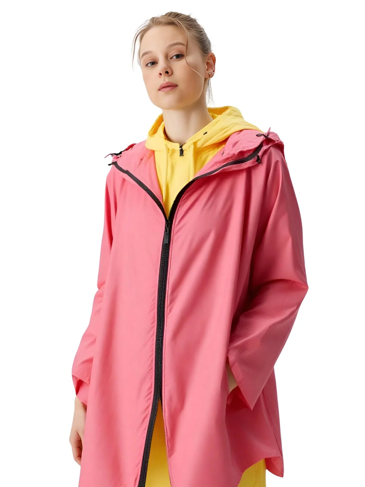 Person wearing a pink raincoat with a yellow inner lining on a white background
