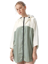 Thumbnail for Woman wearing a two-tone raincoat with white and green sections on a white background