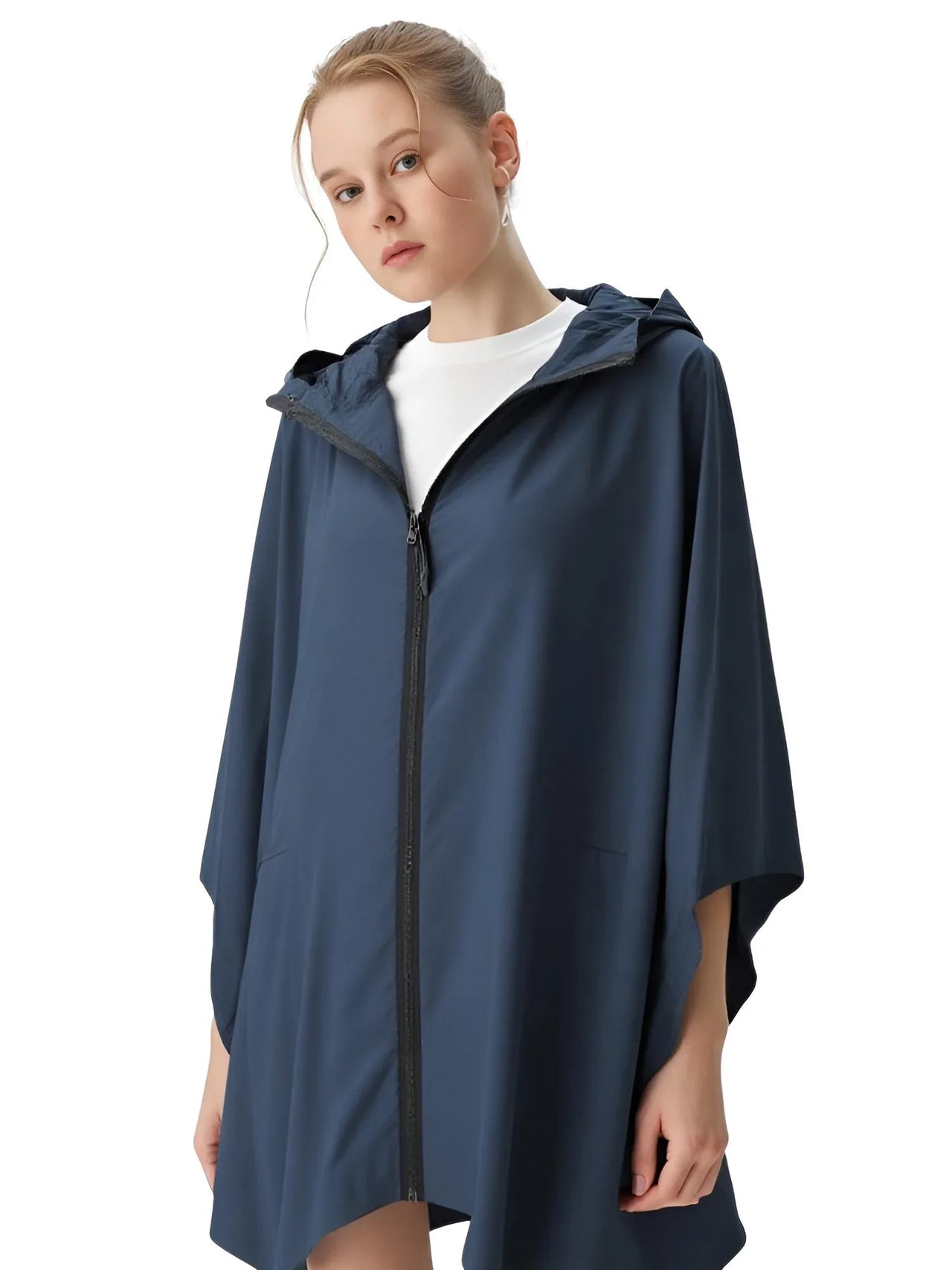 Person wearing a navy blue rain poncho on a white background
