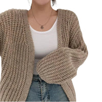 Thumbnail for Beige knitted cardigan over a white top and jeans on a white background