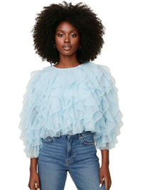 Thumbnail for Woman wearing a light blue ruffled blouse and jeans on a white background