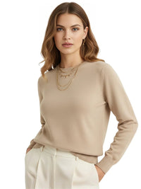 Thumbnail for Woman wearing a khaki sweater and white pants on a white background