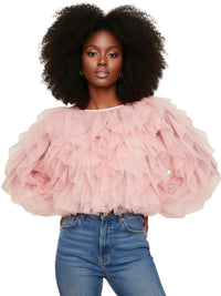 Thumbnail for Woman wearing a pink ruffled blouse and blue jeans on a white background