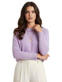 Thumbnail for Woman wearing a purple sweater and white pants on a white background