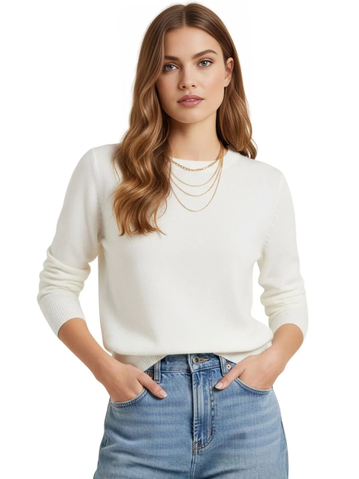 Woman wearing a white sweater and blue jeans on a plain background