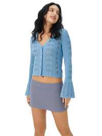 Thumbnail for Woman wearing a blue flare sleeve cardigan and skirt on a white background