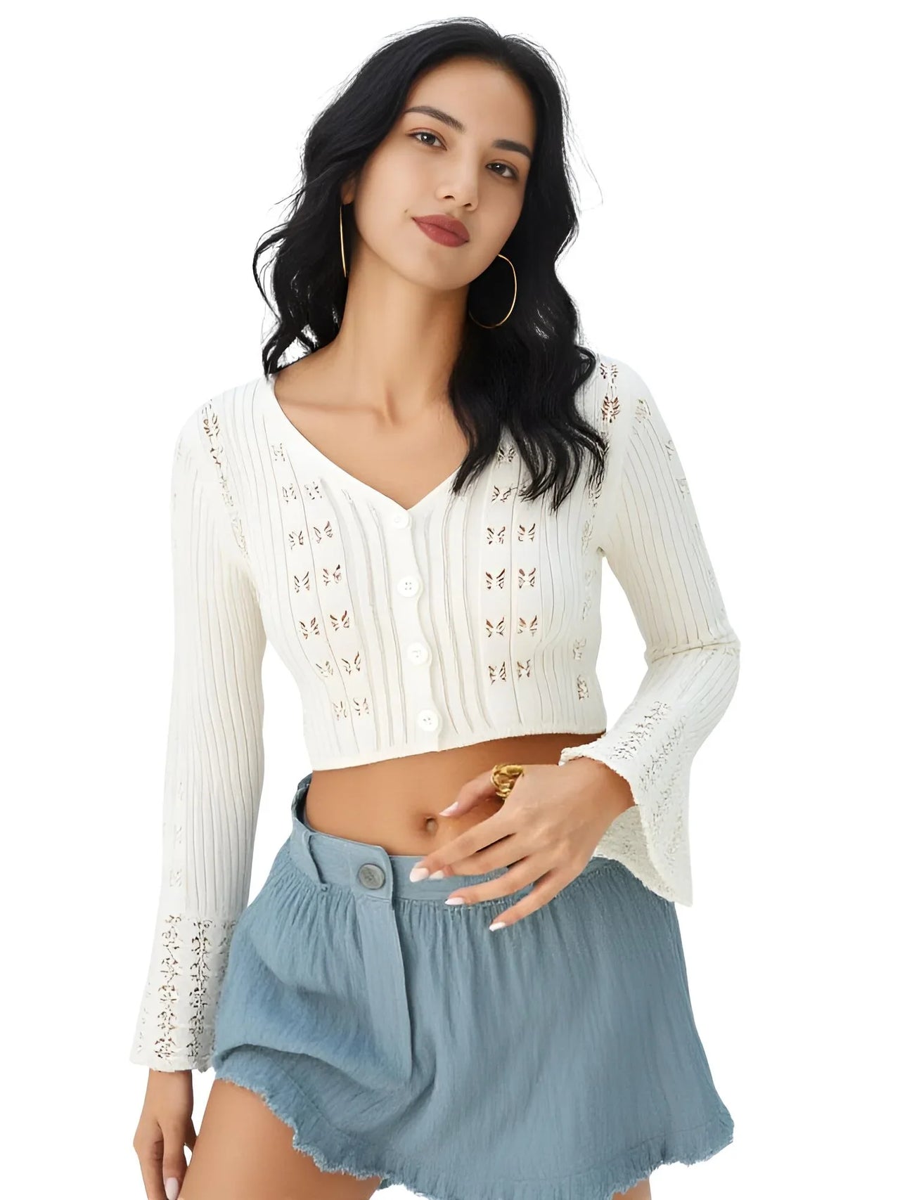 Woman wearing a white flare sleeve top and blue shorts on a white background