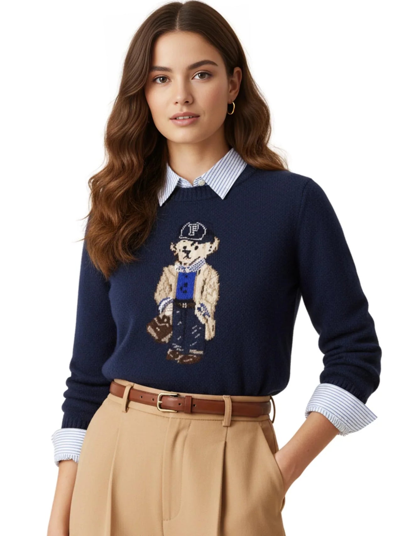 Woman wearing a navy pullover sweater with a teddy bear design on a white background