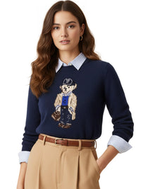 Thumbnail for Woman wearing a navy pullover sweater with a teddy bear design on a white background