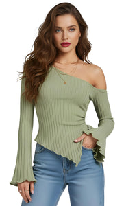 Thumbnail for Woman wearing an olive green ribbed asymmetrical  off shoulder sweater with long flared sleeves and blue jeans on a white background