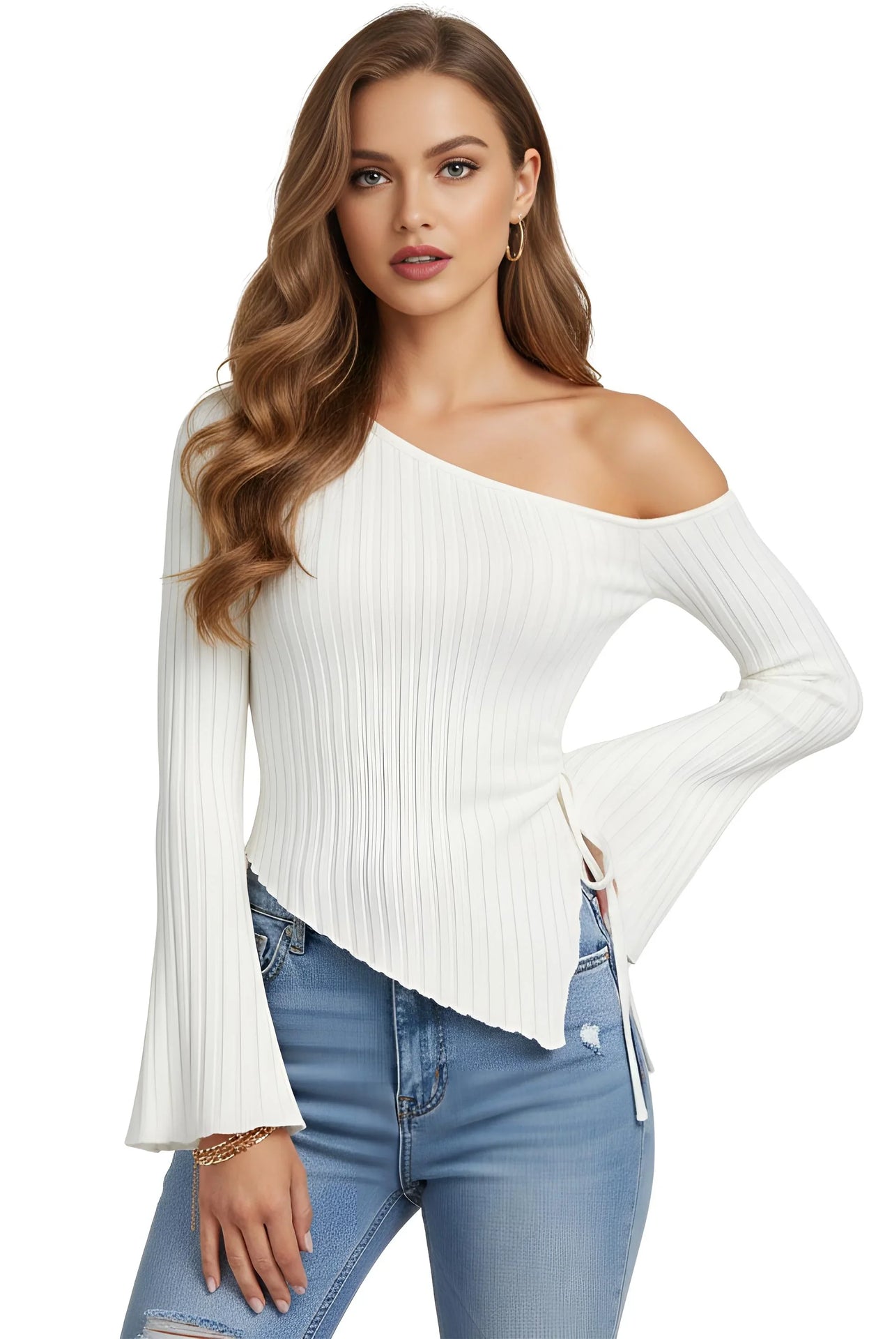 Woman wearing a white off-shoulder asymmetrical ribbed sweater with long flared sleeves and blue jeans on a white background
