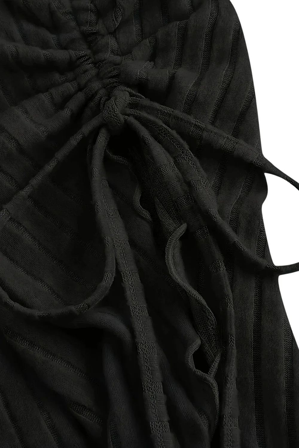 Black fabric with a tied bow detail on a white background