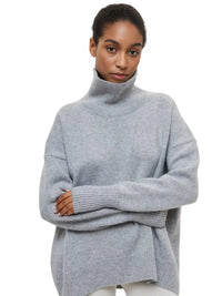 Thumbnail for Woman wearing a grey turtleneck sweater on a white background