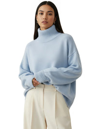 Thumbnail for Model wearing Drestiny Women's Oversized Turtleneck Sweater in soft pastel blue with ribbed neck and cuffs, styled with cream tailored trousers for a minimalist, luxe look.