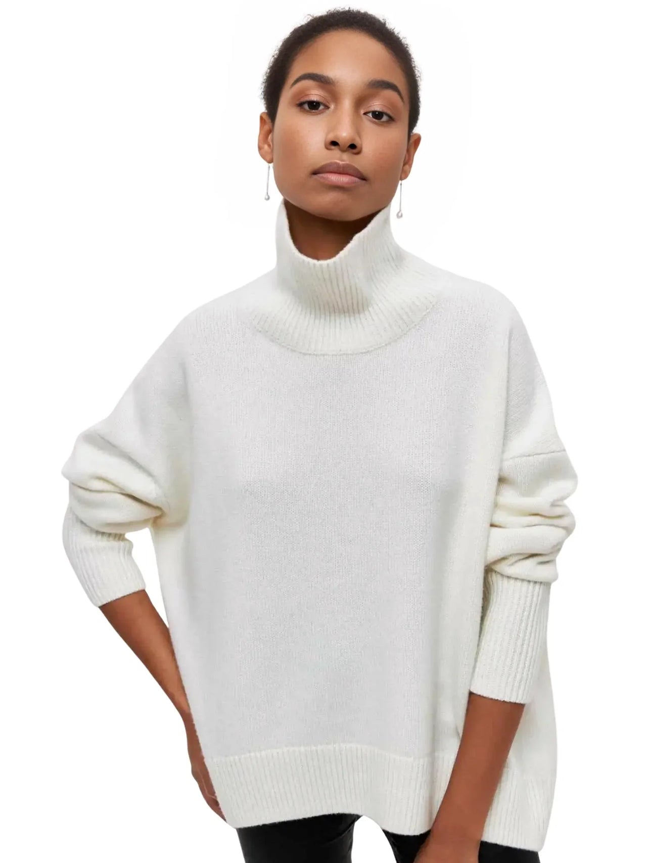 Woman wearing a white turtleneck sweater on a white background