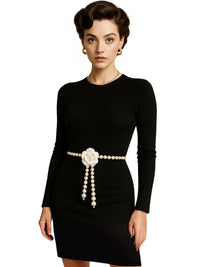 Thumbnail for Woman wearing a black dress with a pearl waist belt on a white background