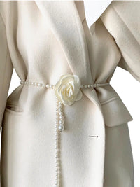 Thumbnail for Beige coat with a white camellia flower and pearl belt on a white background