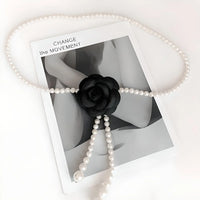 Thumbnail for Pearl waist belt draped over a black flower on a photo with 'CHANGE THE MOVEMENT' text.