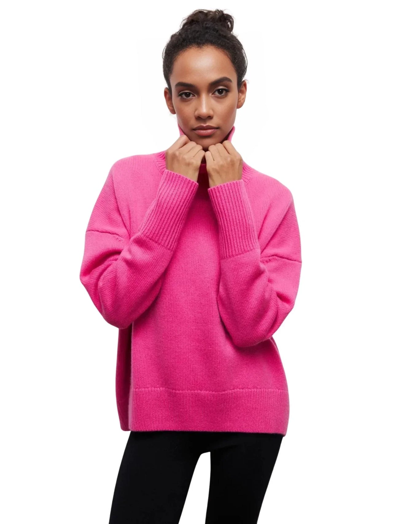 Person wearing a bright pink sweater on a white background