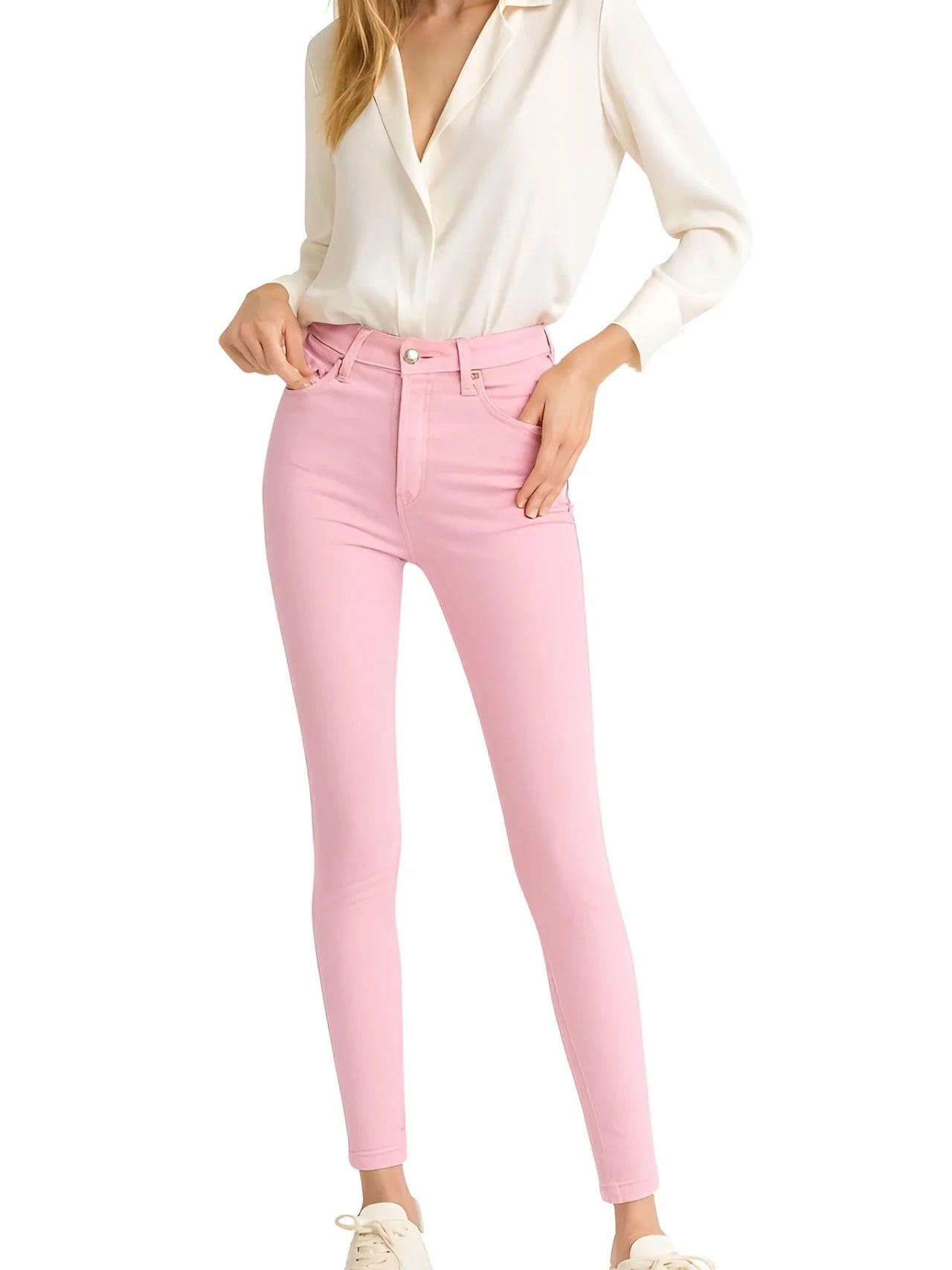 Person wearing pink skinny jeans and a white shirt on a white background