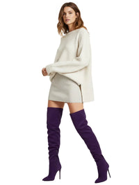 Thumbnail for Woman wearing a cream sweater and skirt with purple thigh-high suede boots on a white background