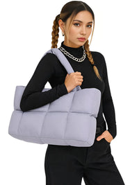 Thumbnail for Woman carrying a purple puffer bag against a white background