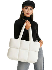 Thumbnail for Woman holding a white puffer bag against a white background