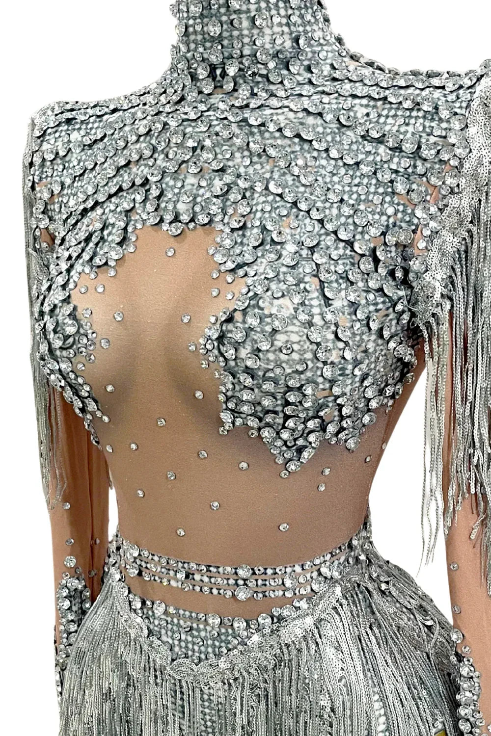 Silver beaded top with fringe details on a mannequin against a white background