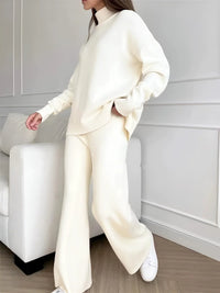 Thumbnail for woman wearing a white knit set in a minimalistic room.