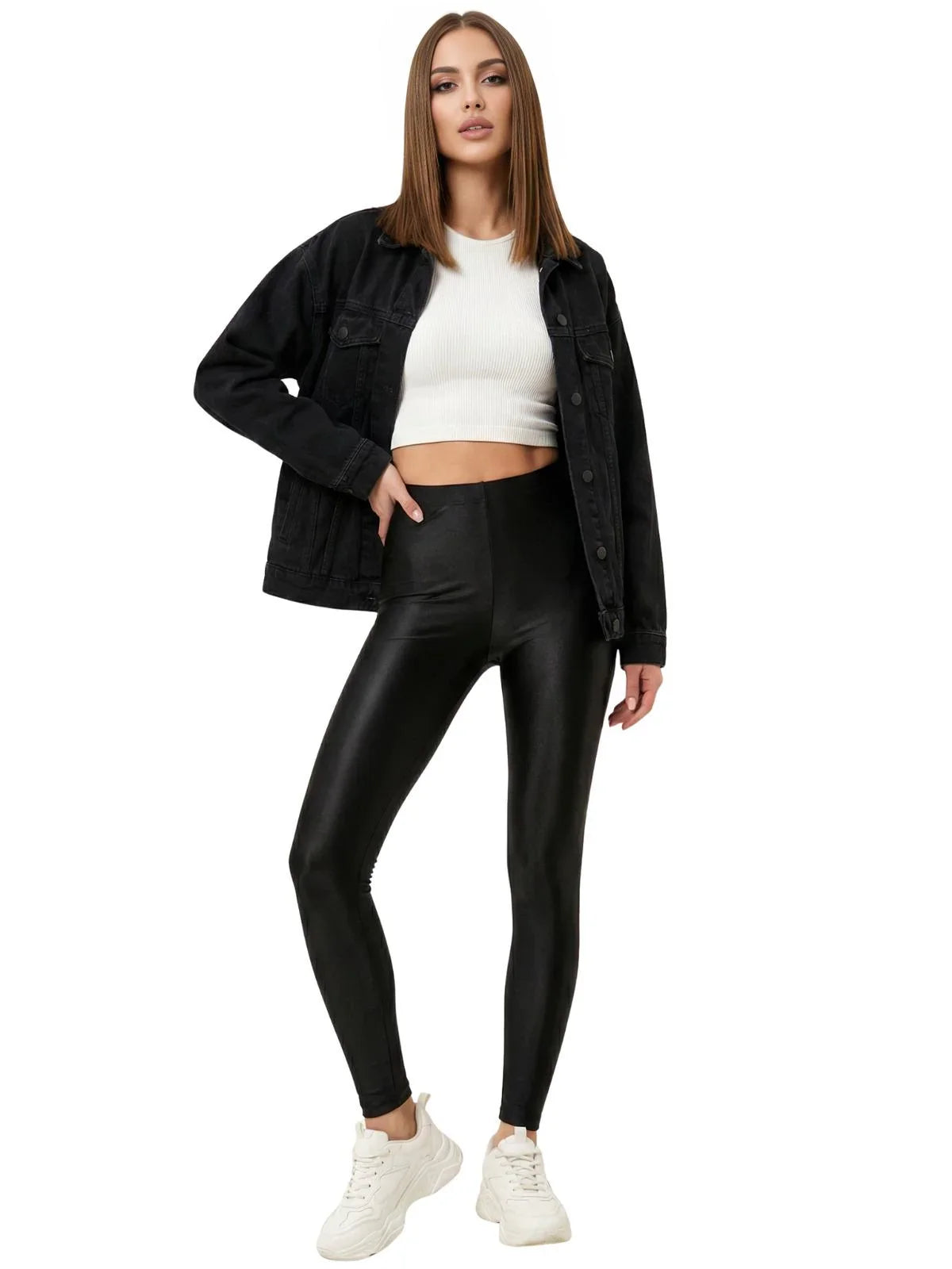 Woman wearing a black jacket, white top, and black leggings on a white background