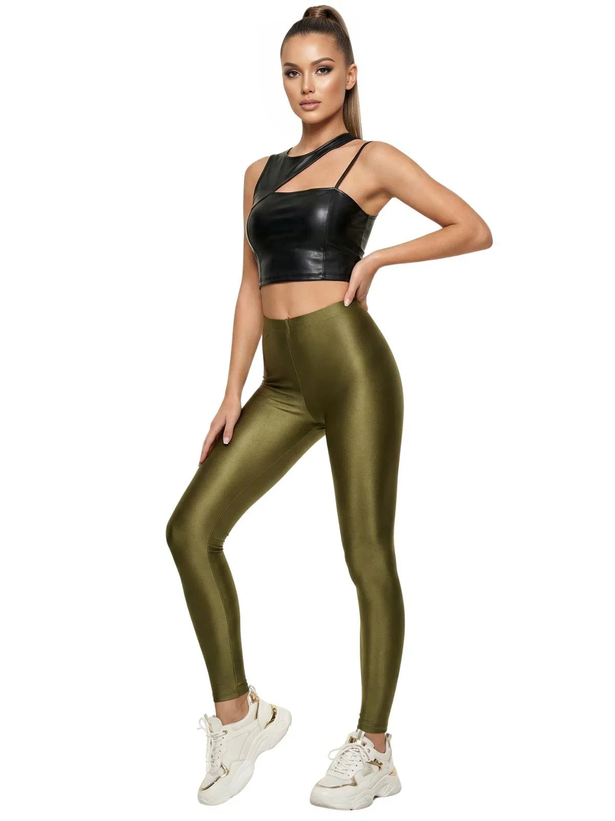 Woman wearing a black crop top and green leggings on a white background