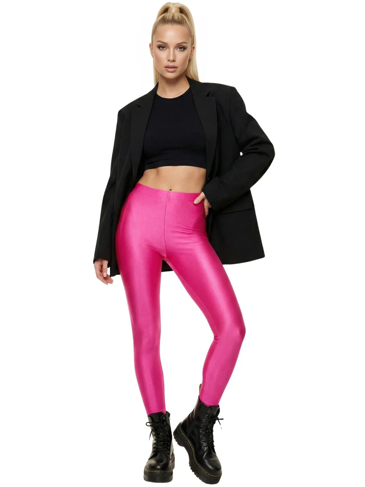 Woman wearing a black blazer, black top, and hot pink leggings on a white background