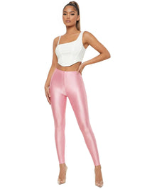 Thumbnail for Woman wearing a white top and pink leggings on a white background