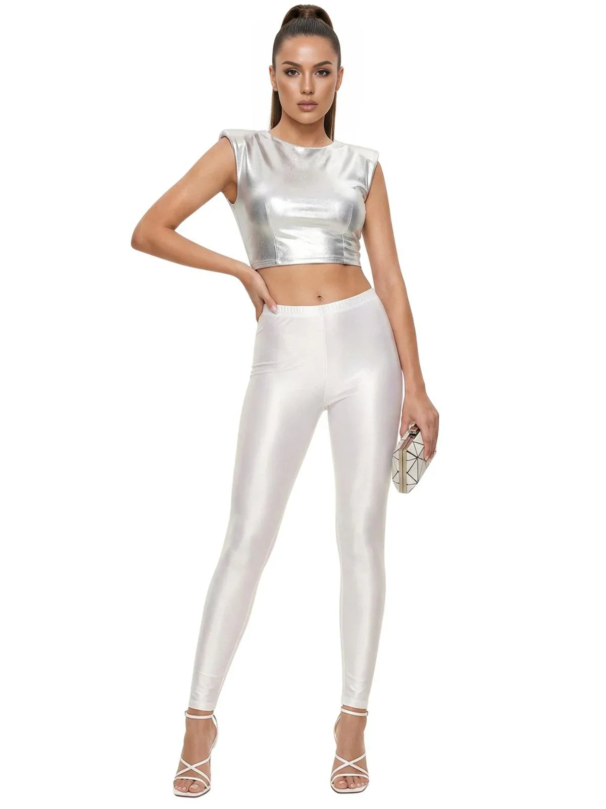 Woman wearing a silver top and white leggings on a white background