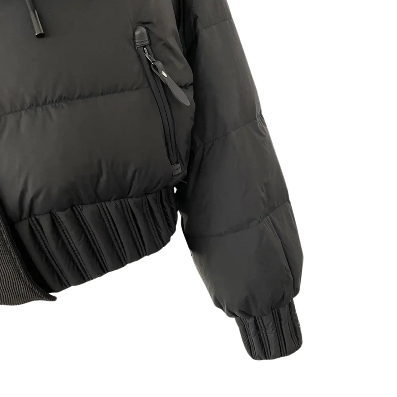 Black puffer jacket with ruffled hem on a white background