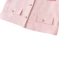 Thumbnail for Close-up of a pink jacket with gold button details on a white background
