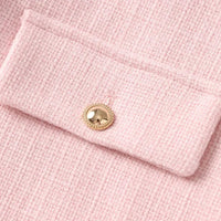 Thumbnail for Close-up of a pink textured fabric with a gold button detail
