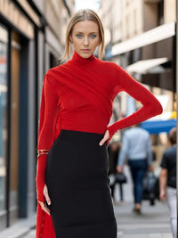 Thumbnail for Woman wearing a red turtleneck and black skirt on a city street.