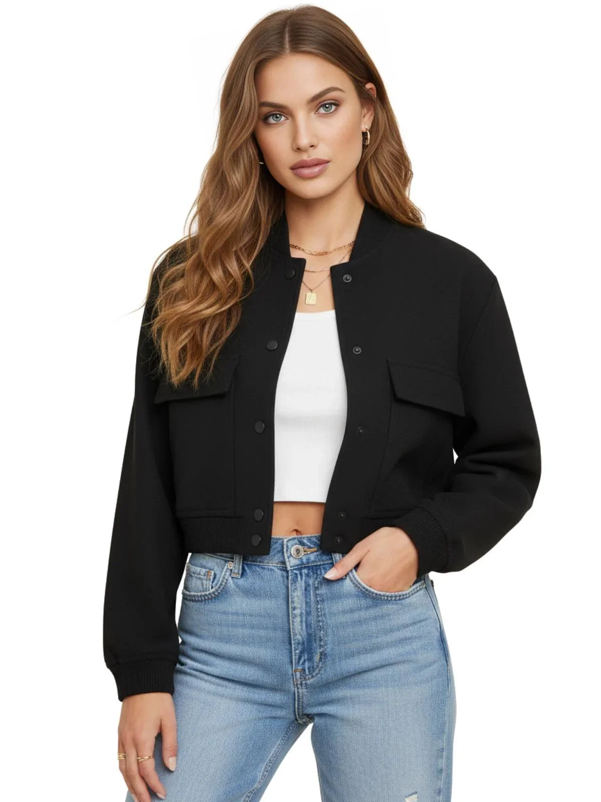 Woman wearing a black bomber jacket, white top, and blue jeans on a white background