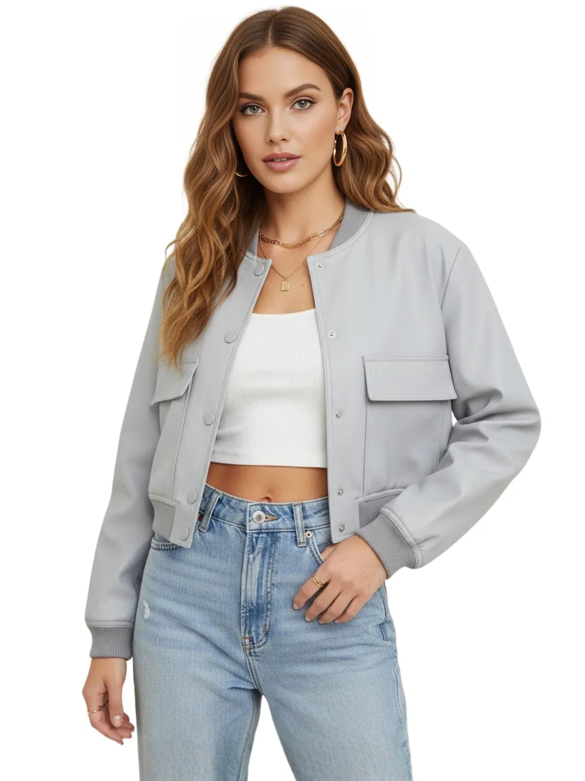 Woman wearing a gray bomber jacket, white top, and blue jeans on a white background