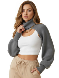 Thumbnail for Woman wearing a gray sweater with cut-out shoulders, white top, and beige pants on a white background