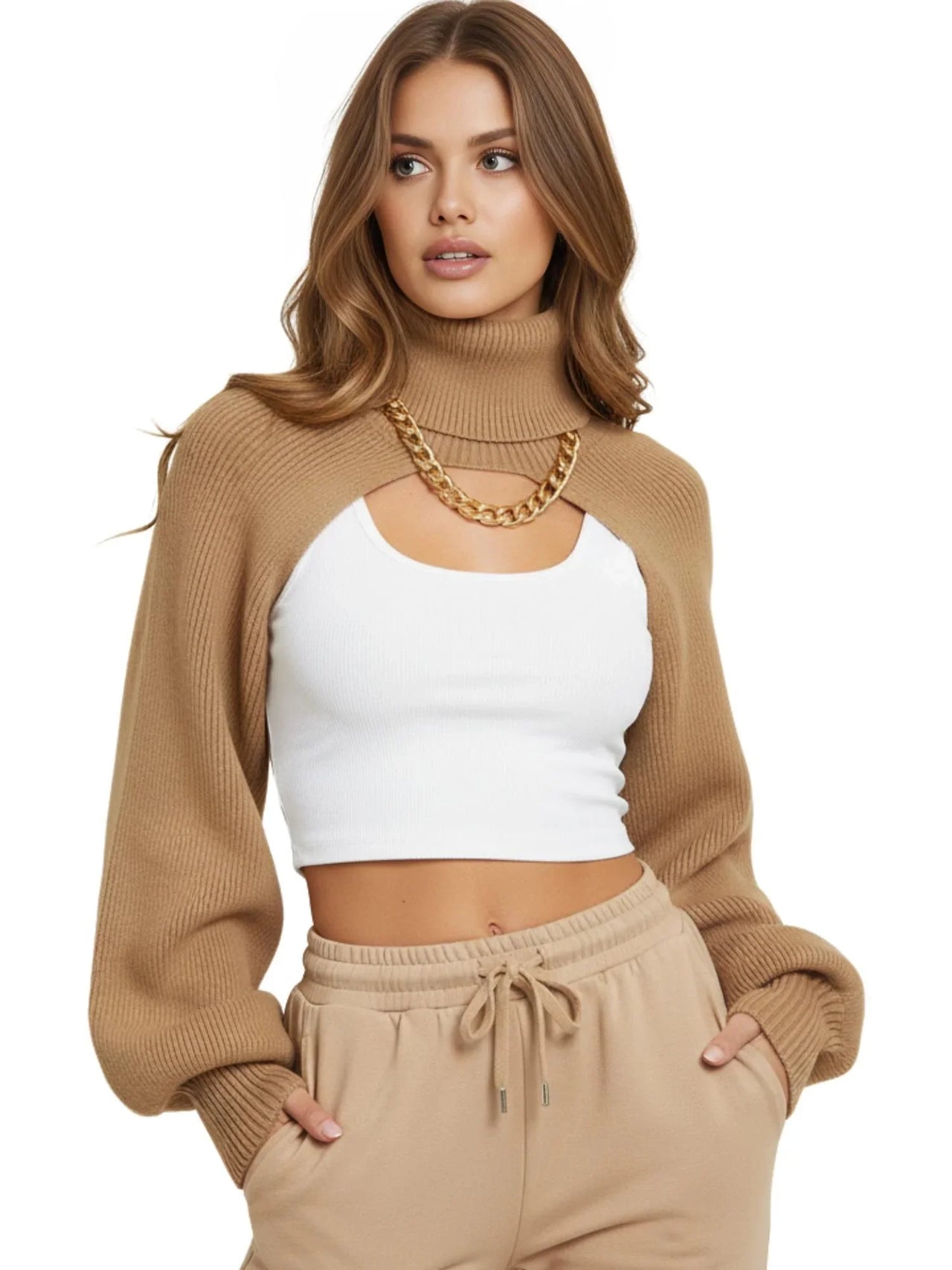 Model wearing Drestiny Women's Turtleneck Bolero Sweater in camel with balloon sleeves and cropped design, styled over a white ribbed tank top and beige joggers for a trendy streetwear look.
