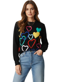Thumbnail for Woman wearing a black sweater with colorful heart patterns on a white background