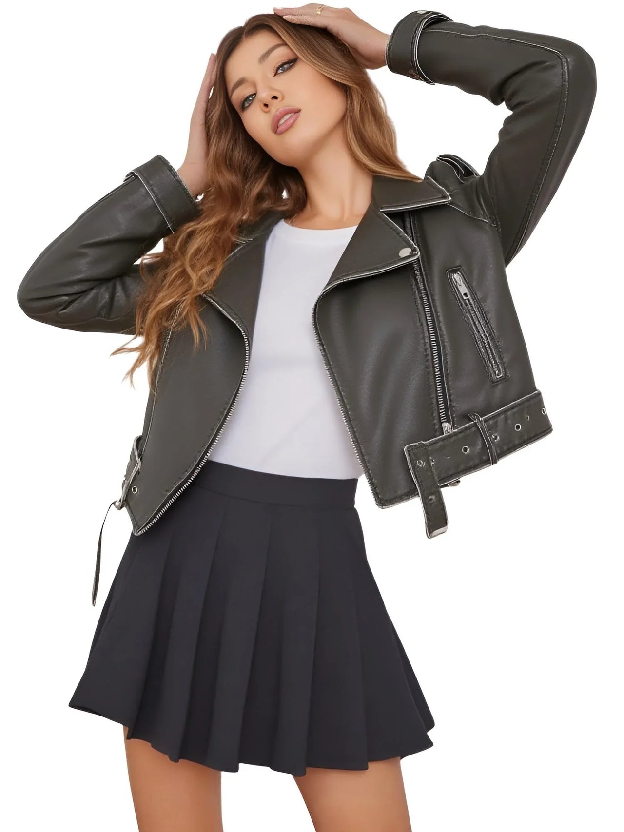 Woman wearing a coal grey leather jacket, white top, and black pleated skirt on a white background
