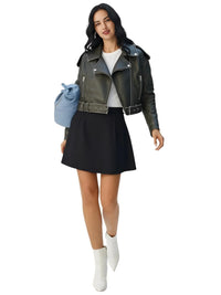 Thumbnail for Woman wearing a coal grey leather jacket, black skirt, and white boots on a white background