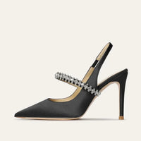 Thumbnail for Black high-heeled shoe with crystal embellishments on a light gray background