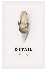Thumbnail for Gray high-heeled shoe with a decorative strap on a light pink background