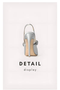 Thumbnail for Silver high-heeled shoe with decorative elements on a light gray background